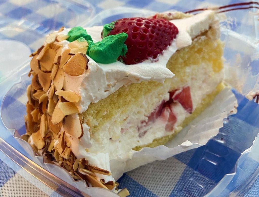 Delicious strawberry, almond, and whipped cream cake slice in downtown Los Angeles on To Live and Dine in LA Food Tours' Chinatown and Olvera Street Food Tour.