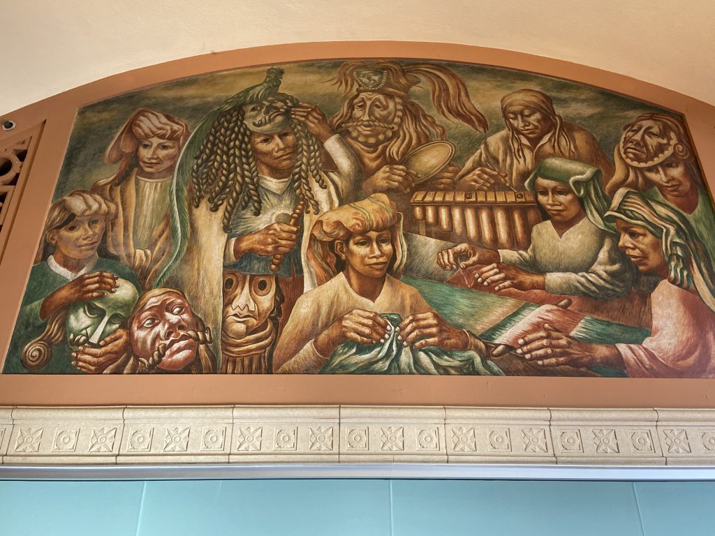 Boris Deutsch's Works Progress Administration (WPA) mural depicting indigenous people with masks and musical instruments in the Los Angeles Terminal Annex Post Office in downtown Los Angeles on To Live and Dine in LA Food Tours' Chinatown and Olvera Street Food Tour.
